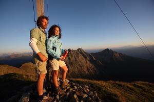 Sunrise at the summit cross of the Hirzer