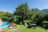 Garden with lawn for sunbathing, sitting area and swimming pool